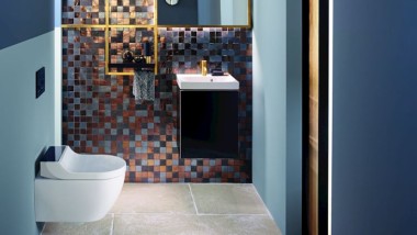 Gold and copper tones add warmth to this guest bathroom